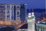 Anjum Hotel Makkah at night with the clock tower in the distance